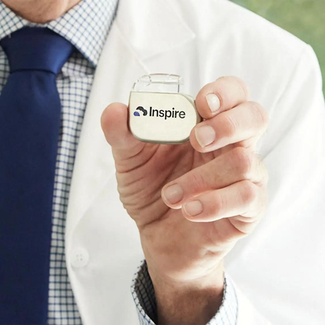 Doctor holding an Inspire Implant.